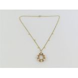 A 9ct gold pearl set wreath style pendant, on a c