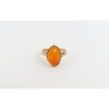 An orange paste stone ring, marked '9ct', finger s