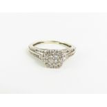 An unmarked white metal diamond dress ring, the ce