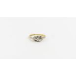 A three stone diamond twist ring, marked '18ct pla