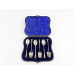 A cased set of silver tea spoons, the bowls in the