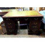 A 20th Century pedestal desk with tooled green lea