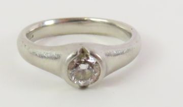 A platinum diamond solitaire ring, the rub over se