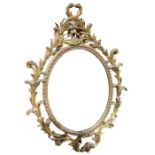 A large decorative gilt wall mirror with scrolling