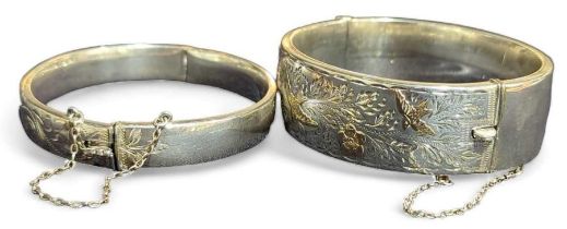 A silver hinged bangle, with half engraved decorat
