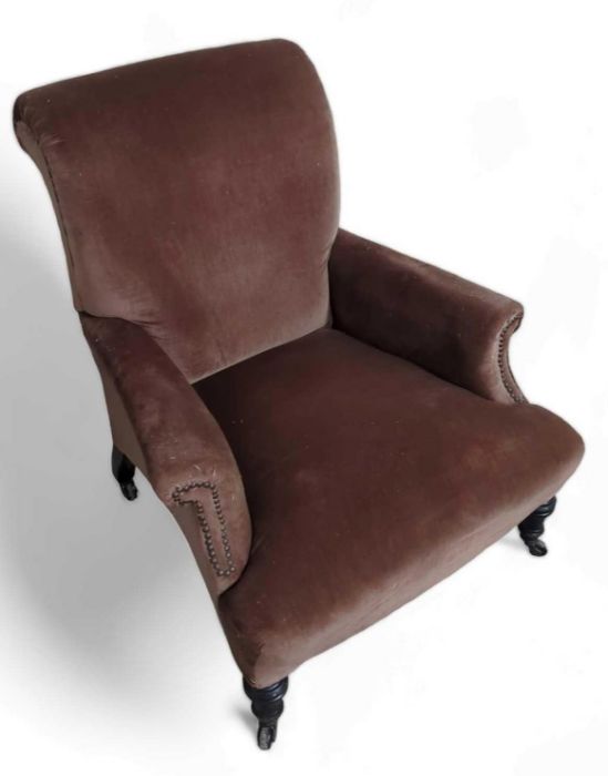 A 19th century armchair, with brown upholstery, 68