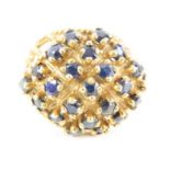 An unusual 9ct gold sapphire set bombe style ring,
