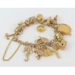 A 9ct gold fancy link bracelet, with various charm