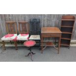 A wooden bookcase, various chairs, wine table and