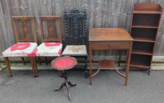 A wooden bookcase, various chairs, wine table and