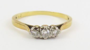 An 18ct gold diamond three stone ring, finger size