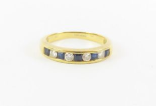 An 18ct gold sapphire and diamond half eternity ri