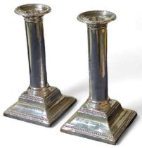 A pair of silver candlesticks, by Hawksworth, Eyre