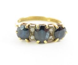 A sapphire and diamond ring, marked '18ct', finger