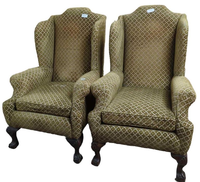 A pair of Georgian style wingback upholstered armc