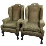 A pair of Georgian style wingback upholstered armc