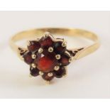 A 9ct gold garnet cluster ring, finger size P, 1.8