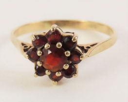 A 9ct gold garnet cluster ring, finger size P, 1.8