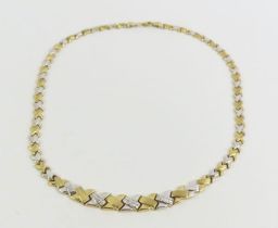 A 9ct yellow and white gold X link necklace, 43cm