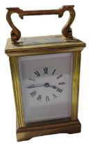 A brass cased travelling timepiece having white en