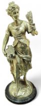 A silvered metal sculpture modelled as a lady carr