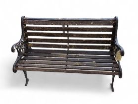 A weathered blacked painted wrought iron framed ga