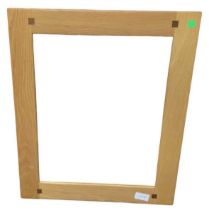 An Ernest Menard light oak framed wall mirror