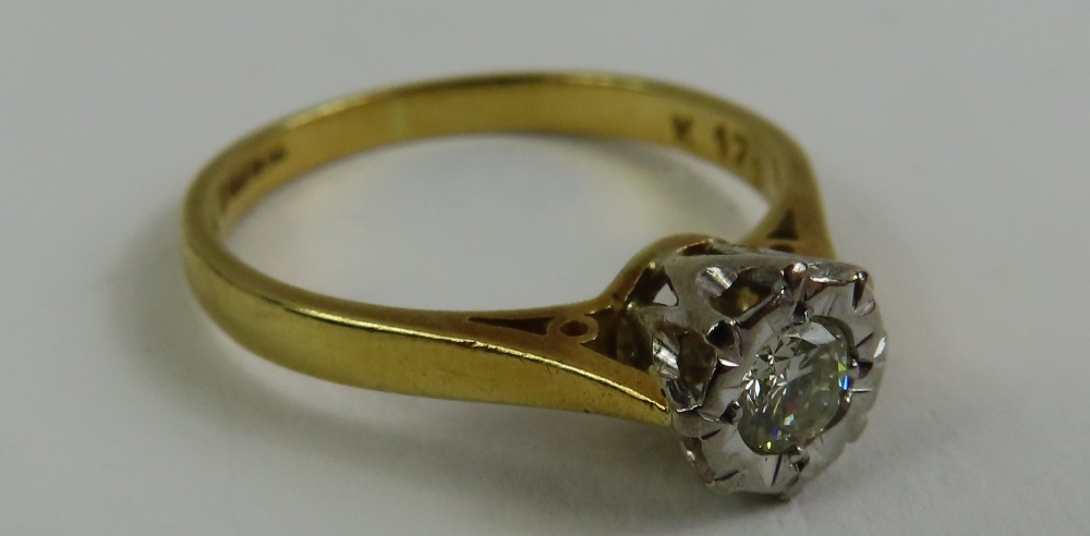 An 18ct gold illusion set diamond solitaire ring,