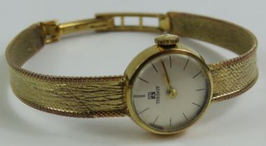 A ladies 9ct gold Tissot wristwatch, the round whi