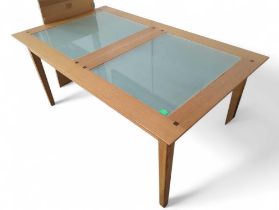 An Ernest Menard light oak and frosted glass dining table