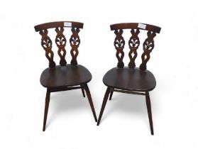 Two Ercol dark elm dining chairs