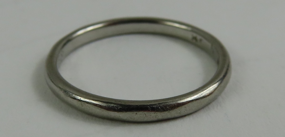 A wedding ring marked 'PLATINUM', finger size M 1/