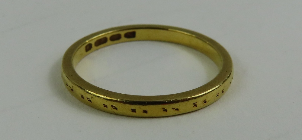 A 22ct gold wedding band, with worn pattern, finge