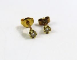 A pair of 18ct gold diamond stud earrings, the dia
