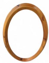 A Contemporary orange pine framed oval wall mirror