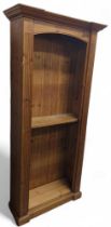 A contemporary open pine bookcase, with
