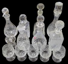A collection of moulded and cut glass decanters, a
