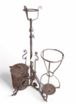 A wrought iron lamp stand, a pot and cover