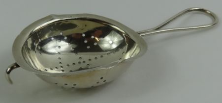 A silver tea strainer, by William Hutton & Sons, B