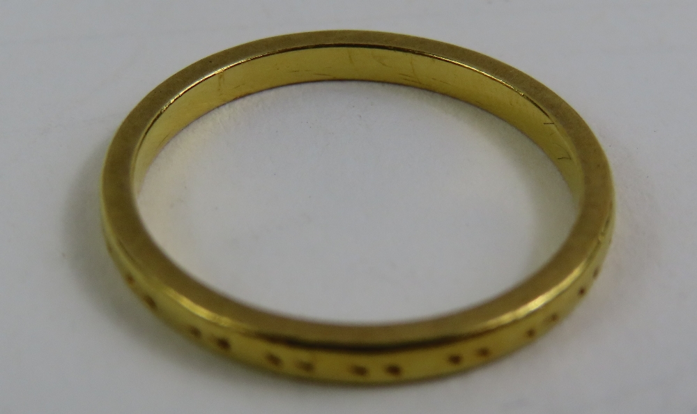 A 22ct gold wedding band, with worn pattern, finge - Image 4 of 4