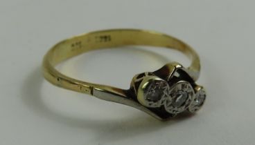 A diamond three stone twist ring, marked '18ct 18c