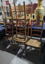 A set of five beech ladder back chairs with rush s