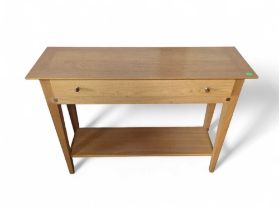An Ernest Menard light oak console table with single draw