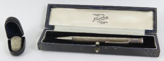 A silver cased propelling pencil with guilloche de