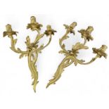 A pair of Rococo style gilt brass three branch wal