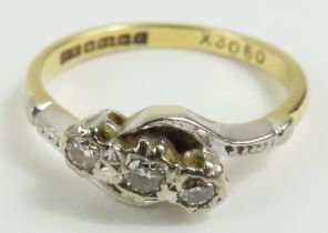 An 18ct gold three stone diamond twist ring, finge