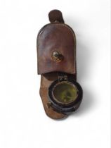 A WWII period marching compass in brown leather ca