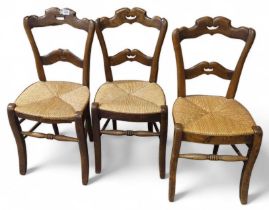 A set of three rush seated chairs