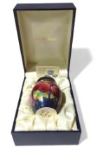 A Moorcroft enamels miniature pot and cover, pomeg