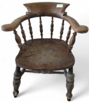 A 19th Century Windsor smokers chair with elm seat